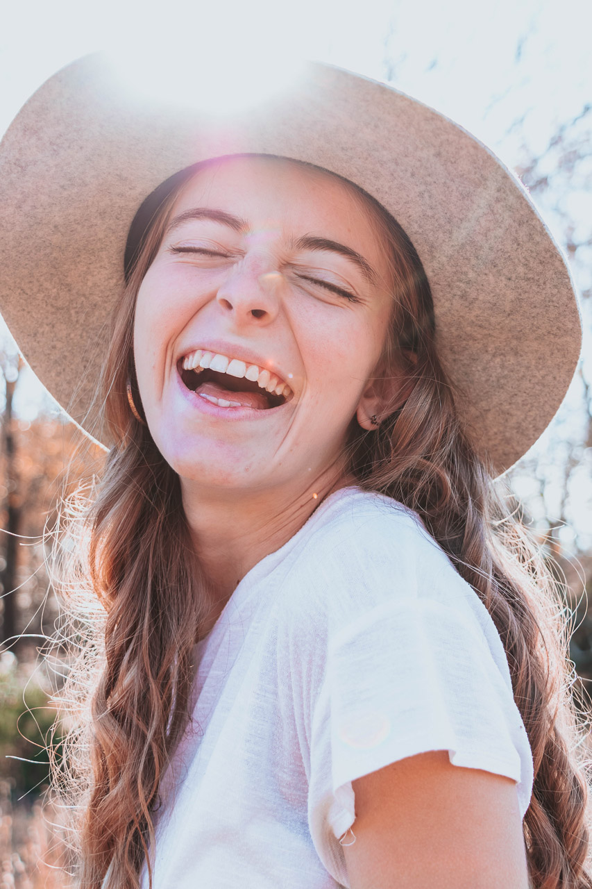 backlit woman smiling at camera
